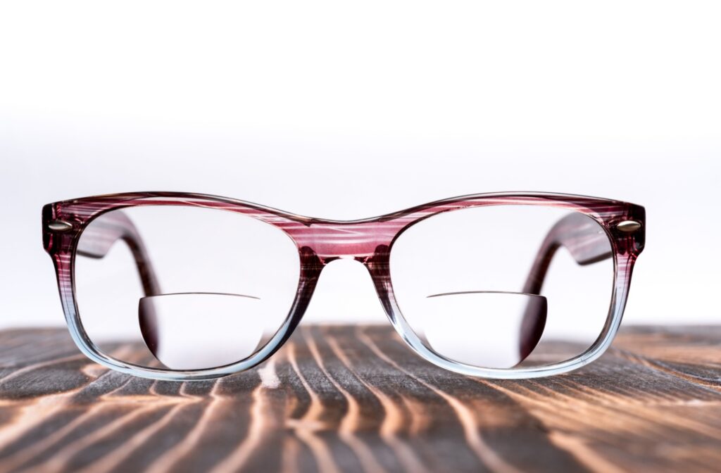 A close-up photo of bifocal glasses sitting on a table.