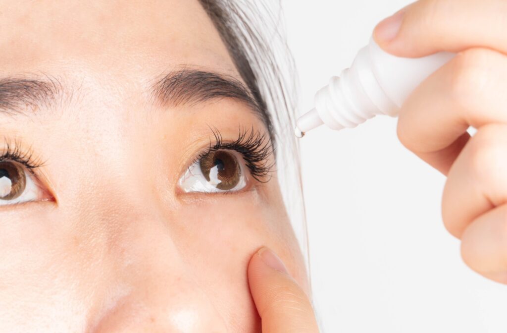 A person inserting eye drops to help manage symptoms of dry eye disease.